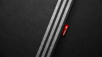 Обои Логотип Adidas на черном фоне. Impossible is nothing 1366x768 скачать  бесплатно на рабочий стол
