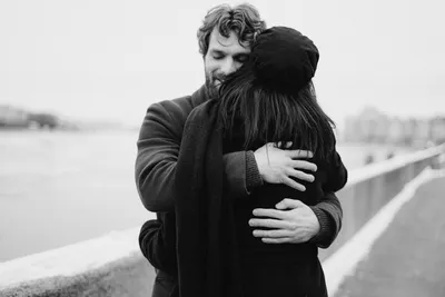 Мужчина и женщина обнимаются на берегу залива · Бесплатные стоковые фото